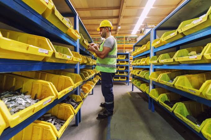 A technician checking stock in a spares store